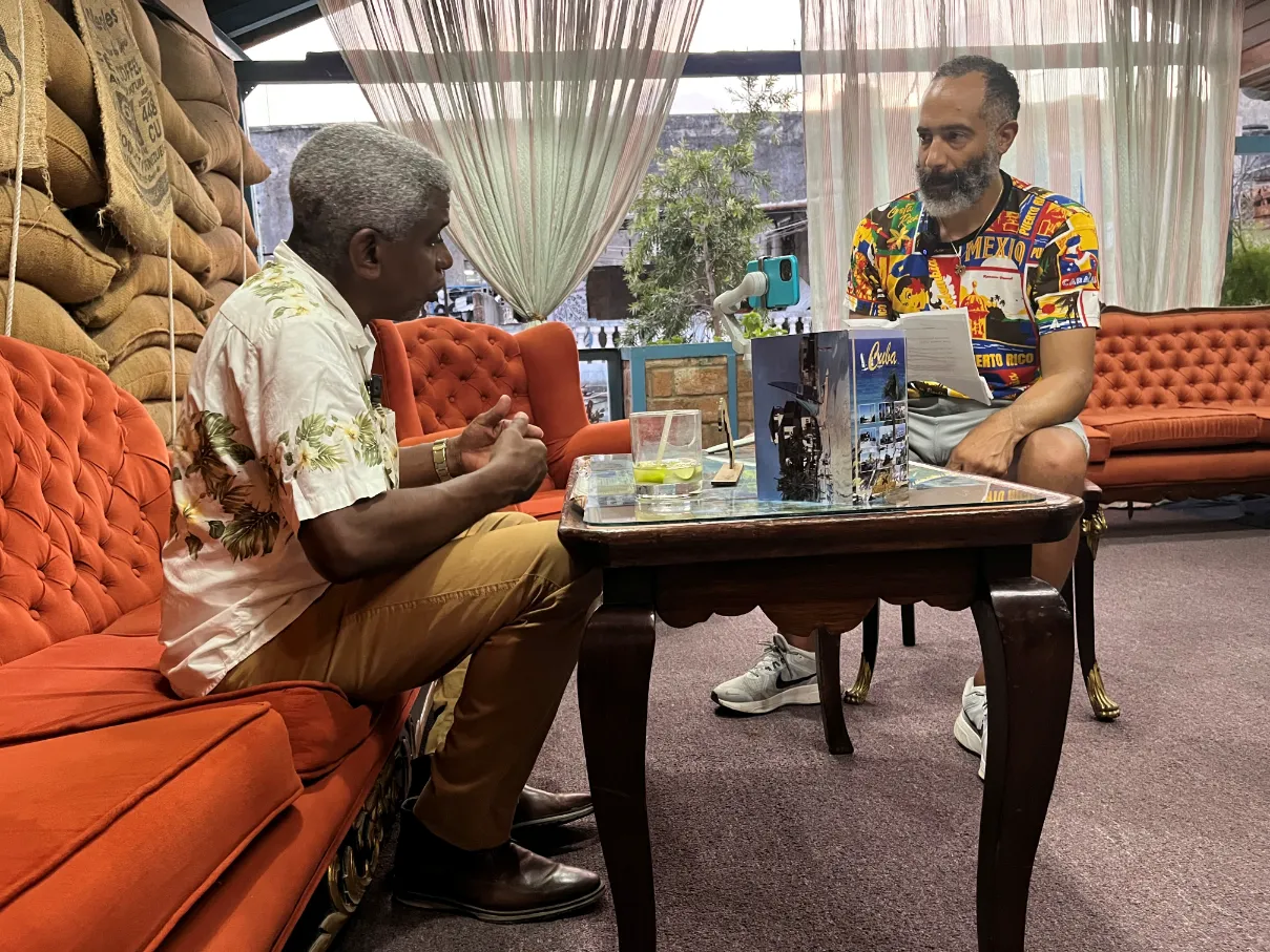 two men sit and speak about AA Registr