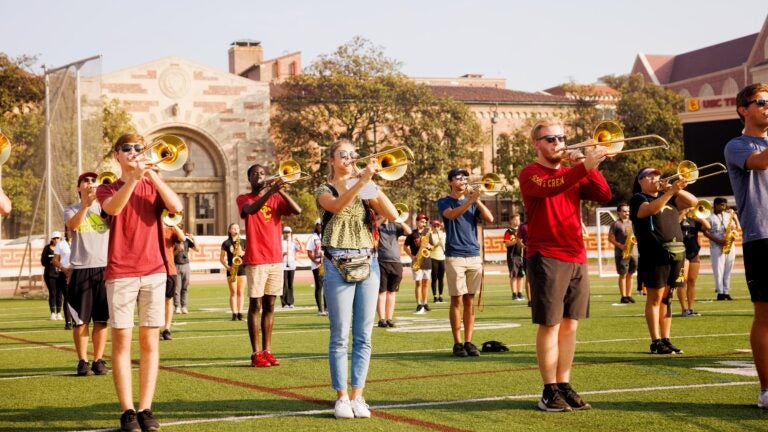 Several band members practicing on the field