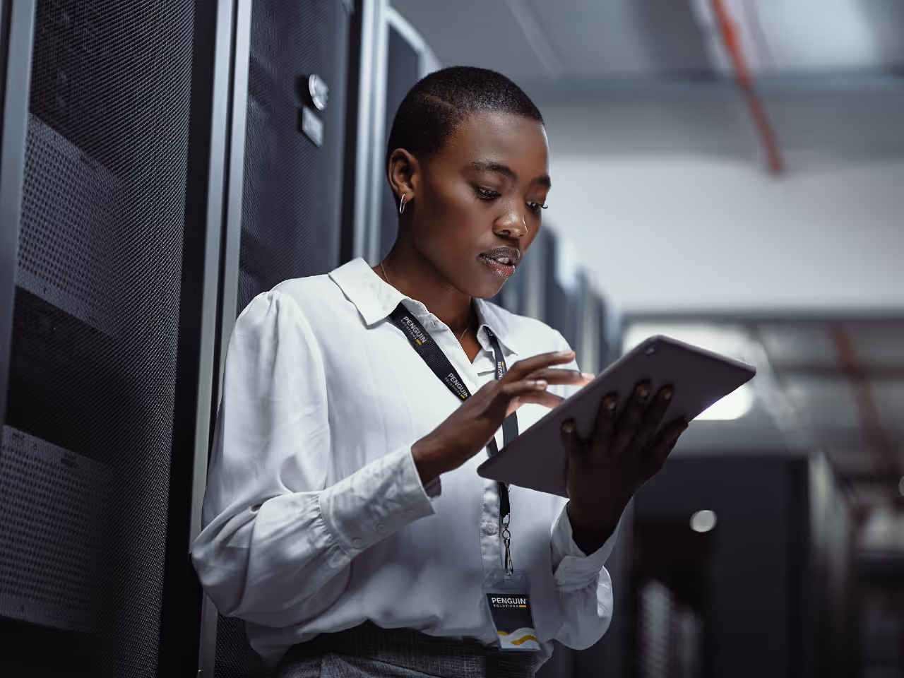 Woman in data center with tablet