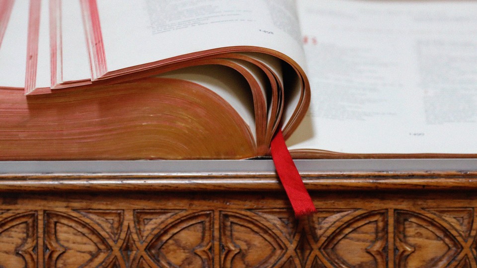 Photograph of a large bible, facing open with a bookmark