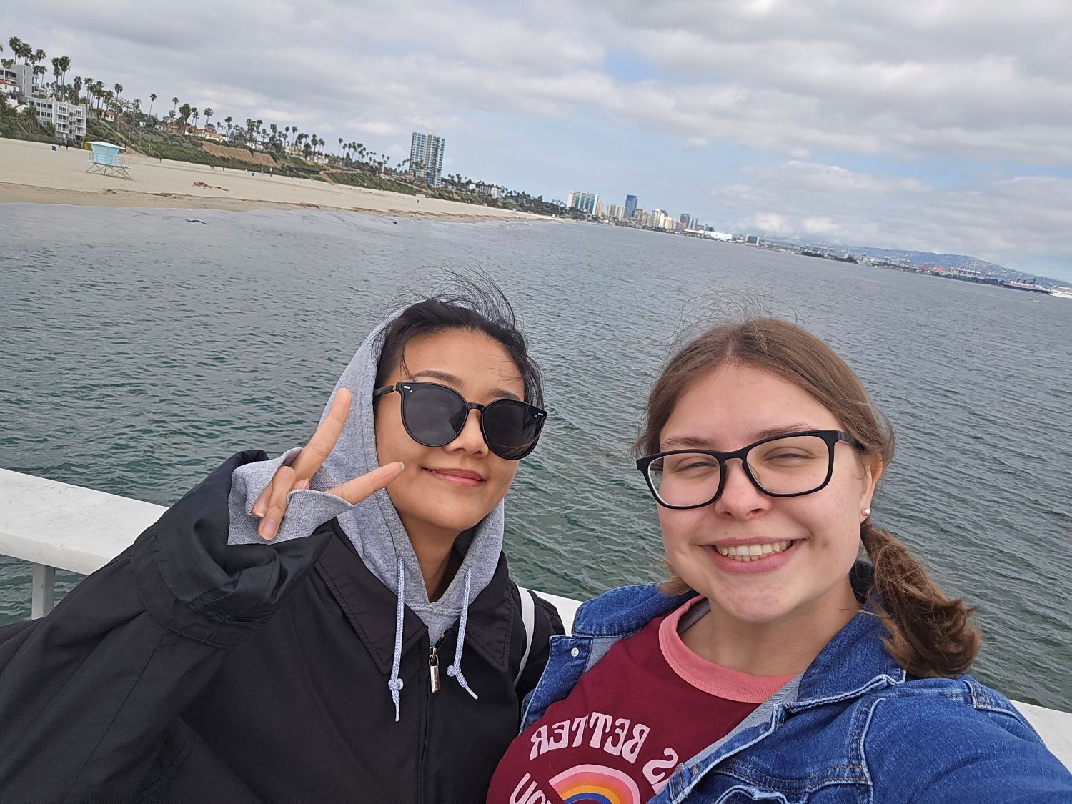 Trinity posing with her friend at the beach