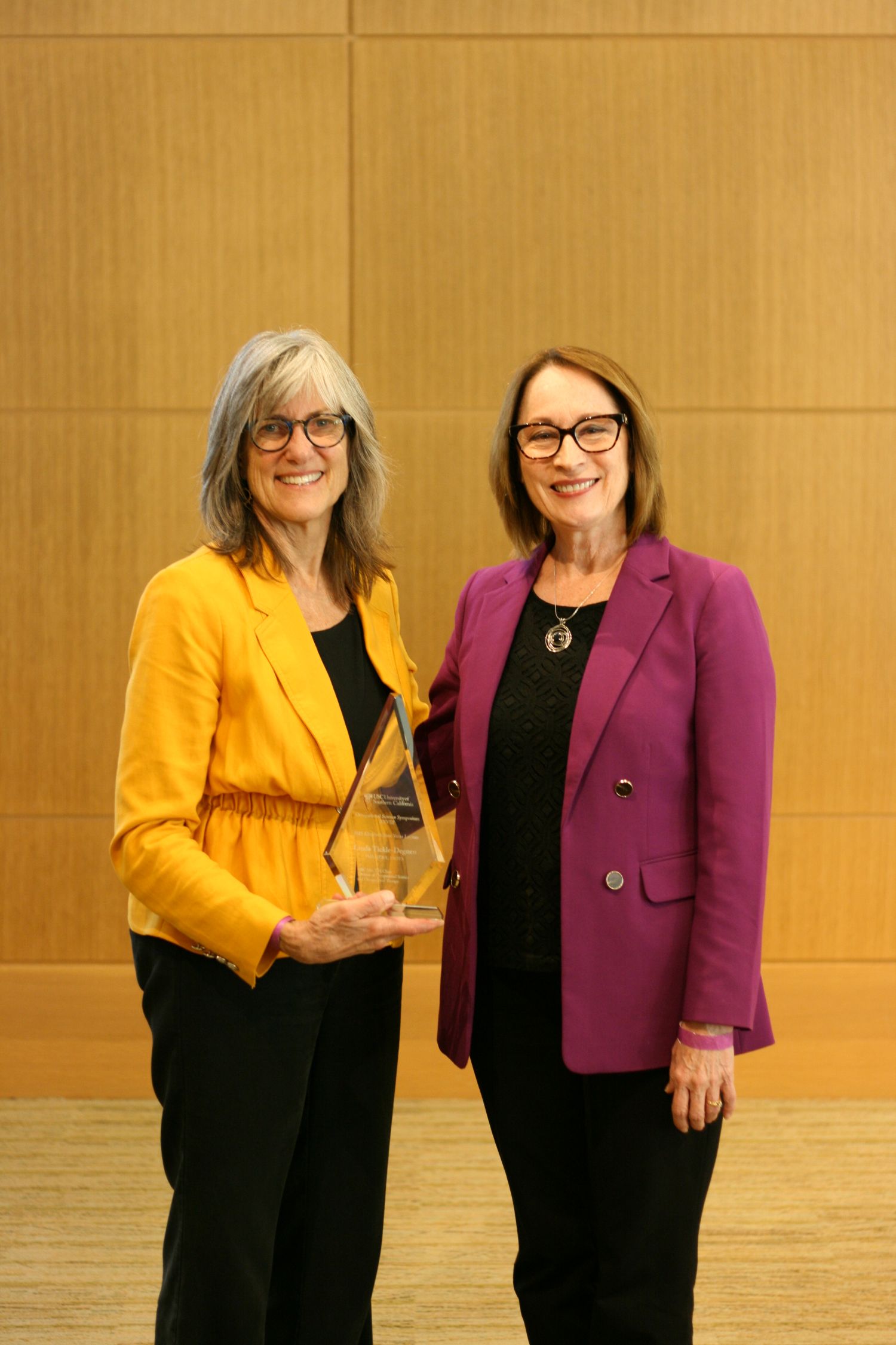 Dr. Tickle-Degnen receiving an award from Dr. Grace Baranek
