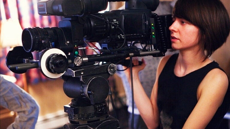 woman operating film camera