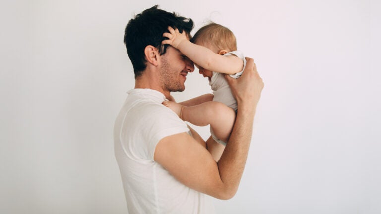 Photo of father holding his baby.