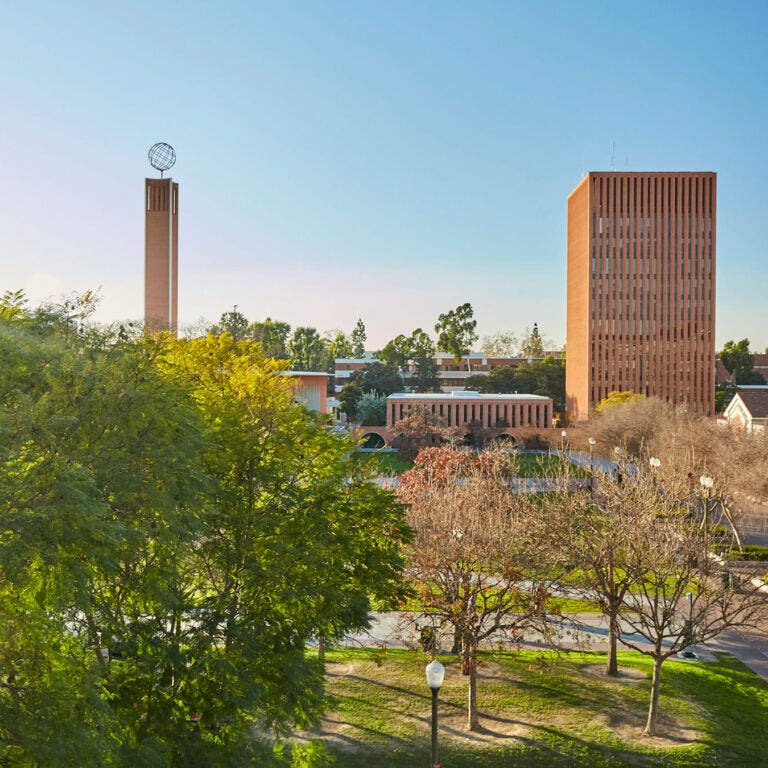 McCarthy Quad with a wide shot of Dr. Joseph Medicine Crow Center for International and Public Affairs and Leavey Library as the sun sets on campus.