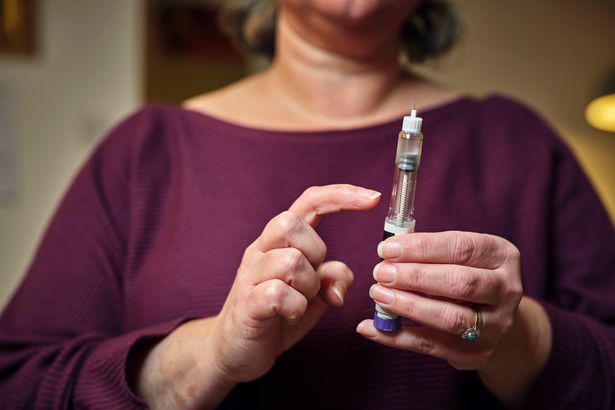 Woman holding a weight loss injection
