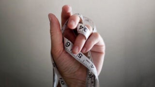 Hand holding tape measure Photo by Jennifer Burk